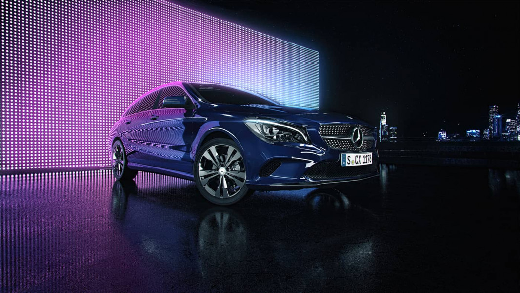 Rendered blue car in front of a purple LED wall